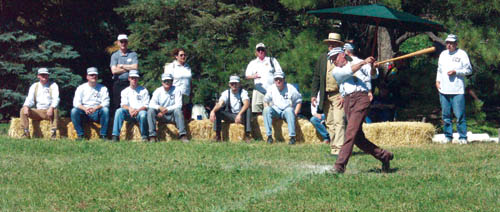 Andy Slugger Morris takes a mighty cut while his Camp Creek Sluggers teammates look on during the old-fashioned 
baseball game Sept. 6 at Rock Ledge Ranch. The annual event drew about 200 spectators.