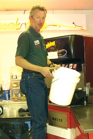 As one of his stocking tasks at the 1st Stop convenience store Mike Firestone adds ice to a drink machine.
Westside Pioneer photo