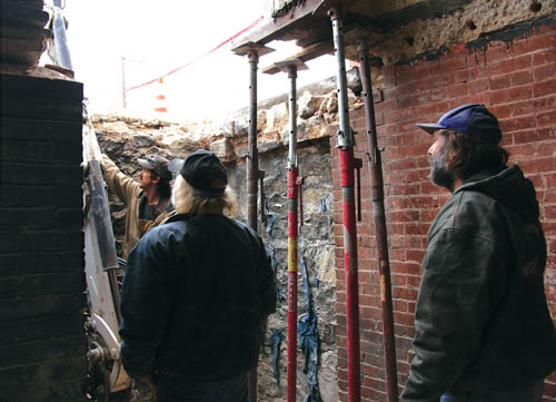 Standing in the basement of Fire Station 5, with the Colorado Avenue sidewalk above them, workers with CMS 
Construction consider the next step of the project to replace an engine bay�s failing concrete slab.
Westside Pioneer photo
