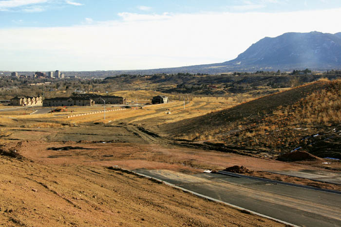 The paved portion of the Centennial Boulevard extension,
built by Colorado Springs Health Partners, is at  right, while
south of it is a few hundred feet of rough grading and then the unpaved segment going past the Indian Hills Village subdivision to Van Buren Street. South of that, no road has been built.
Westside Pioneer photo