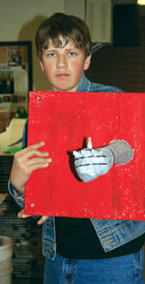 Holmes student Dan Smith �wears� a gauntleted arm in one
of 25 �Pandora�s Box� pieces the school will have in an
exhibit with the Watercolor Society.
Westside Pioneer photo