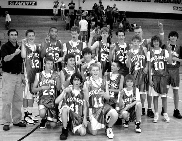 The Holmes Middle School basketball team members hold up
fingers signifying they�re �number one� after winning the
City Classic championship over Jenkins in the title game
March 1 on the Mitchell High School court. Front row,
kneeling (from left): Luke Brown, Drew MacMillan, Tate
Lagasca. Second Row, kneeling (from left): Dan Egger,
Josh Knotek, David Feuerbach, Ben Rather. Third row,
standing (from left): Coach Mike Kreidel, Eric Rayer,
Brandon Tribble, Eric Albers, Clay Campbell, Jason 
Schmidt, Ben Essells, Ethan Strauch. Fourth Row, rear,
standing (from left): EriK Bakken, Justin Ramsey.
Courtesy of Mike Kreidel