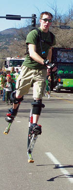 This unidentifed bouncy guy, wearing a springy
contraption that accelerated him along at a speedy clip,
 may have been associated with a bubble-blowing fire 
truck for the Mystic Events Conference Center, which was 
one of the last entries in the parade.