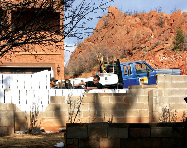 Workers were busy this week installing a retaining wall
behind the White family�s existing wall along the south side
of the alley. The alley is between the Whites and a duplex
project in the 3300 block of West Kiowa. The rock formation
is in the project area. A disagreement led to the unusual side-by-side wall arrangement.
Westside Pioneer photo