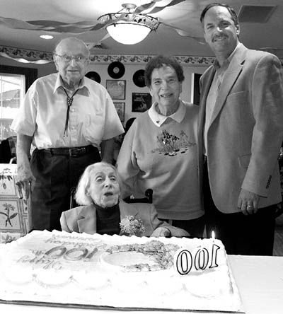 Seated before her 100th birthday cake, Carmen Ceresa
poses with cousins (from left) Tony Biondini, Mary Mayes and her son, Jerry.  
Westside Pioneer photo