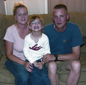 After a year in Iraq, Sgt. Timothy Gibson enjoys the chance to relax in his living room with his wife, Kelly, and daughter, 
Hannah.
