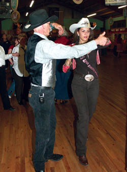 
Ken Owings, an experienced country-western dancer, 
guides National Little Britches Queen Kelli Jackson through 
some steps April 9 at the Carriage Stop. Jackson spent the 
first part of the day helping reopen the ProRodeo Hall of Fame.
Westside Pioneer photo