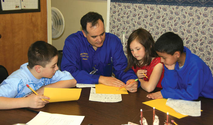 Pike Elementary Principal Manuel Ramsey works with
students during his regularly scheduled math instruction
time. The students are (from left) Andy Laabs, Gabby Hyatt
and Pablo Hernandez. Pike students would relocate to
Jackson, Bristol or Howbert elementaries in 2008-09 under a closure plan that would include the Bijou School moving into the Pike building.
Westside Pioneer photo