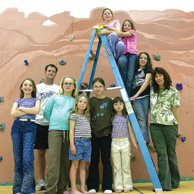 Enjoying the new, muralized climbing wall at Howbert
Elementary are (from left, in front) Kayleigh Wilson, PE
coach Jason Miner, Hayley Messinger, Emma Joines, Kaya Bacon and Aleah Mick, and (from top of ladder) Alicia Mick, Megan McCarrie, Daisy Erickson and artist Deborah Mick.
Westside Pioneer photo