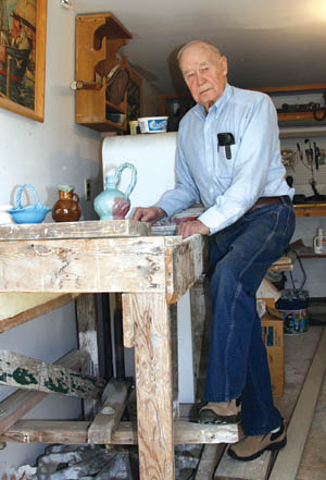 Fred Wills demonstrates the kick wheel he still uses to make pottery originals in his garage. 
Westside Pioneer photo