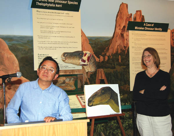Dr. Kenneth Carpenter and Kathleen Brill of the Denver
Museum of Nature & Science answer questions about 
Theiophytalia kerri during a press conference May 24 at the
Garden of the Gods Visitor & Nature Center. The foreground picture is Carpenter�s rendering of the new dinosaur genus/species.
Westside Pioneer photo