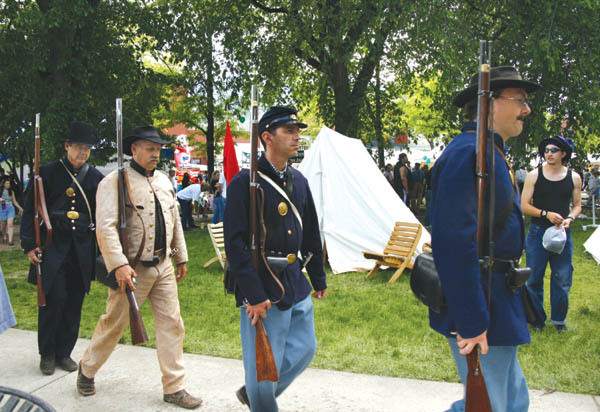 Territory Days scenes in Bancroft Park - Civil War
reenactors (from left, Gary Mitchell, Don Johnson, Sean
Dingle and Paul Bennett) march from their tent encampment.
Westside Pioneer photo
