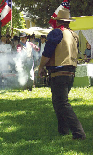 Gold Canyon Gun Fighters fire blanks at each other during a shootout in Bancroft Park. The Gold Canyon group 
performed between musical sets in the Bancroft bandshell.
Westside Pioneer photo