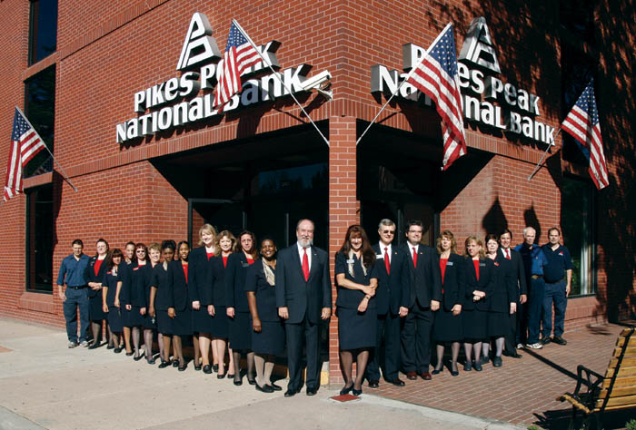 Pikes Peak National Bank President Robin Roberts (in front
of corner post) and CEO John Georgeson (to her right)
pose with the banks Old Colorado City offices employees.
Westside Pioneer photo