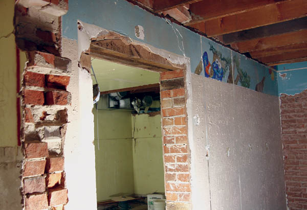 A basement wall shows part of a mural from possibly 20 years ago that had been covered over.
Westside Pioneer article