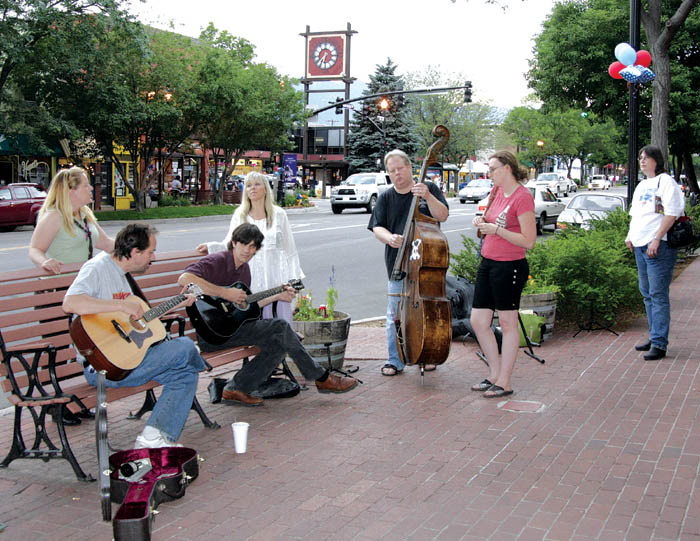 With the 25th and Colorado clock tower in the background,
The Happenstance band performs during the merchants� �Magic in Old Colorado City� promotional event July 5.
Westside Pioneer photo