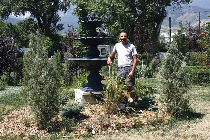 ABOVE: Steve Muzzipapa stands with a fountain hes installed and greenery hes planted on his recently acquired lot at 19th 
and Sheldon.
Westside Pioneer photo