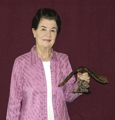 Peggy Lewis holds up one of the bronzes that have been made from the mold for the eagle sculpture that had been 
started by her late son, Rick Lewis.
Westside Pioneer photo