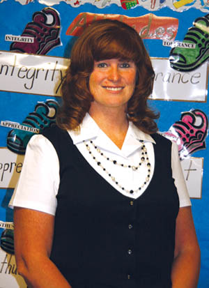 New Midland Elementary Principal Robyn Colbert stands in front of a chart in a classroom listing different points 
related to the Westside school�s International Baccalaureate program.
Westside Pioneer photo