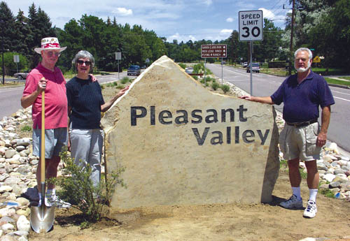 Jim and Carol Corcoran (left) and Dick Wulf of the Pleasant Valley Neighborhood Association stand by the just-
installed entryway sign on 31st Street looking north into the Pleasant Valley subdivision. 
Westside Pioneer photo