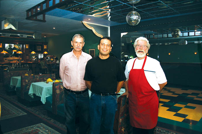 The one-time Checker�s Auto store building at 1201 W.
Colorado Ave. received a major facelift, inside and out,
over the past year during a project to create the Metropolis
restaurant... The key figures in the business (from left)
co-owners Jeff Chevalier and Luis Ortiz and head cook Blair
Hall. Behind them can be seen the dance floor, a table from
the Broadmoor and the solid-mahogany bar.
Westside Pioneer photo