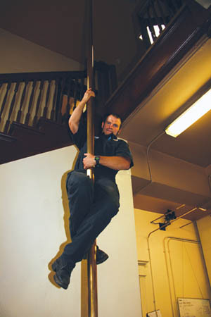 Firefighter/paramedic Tim Krantz slides down the pole in Station 5.
Westside Pioneer photo