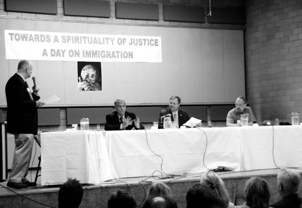 Moderator Tim Fuller (standing) addresses U.S. Senate
candidates Democrat Mark Udall (left), Republican Bob Schaffer and Bob Kinsey of the Green Party at the start
of a forum Aug. 16 in Sacred Heart Church�s gym. Doug Campbell of the American Constitution Party arrived a few minutes later.
Westside Pioneer photo