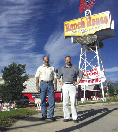 Mike Callicrate (left) and Ken King, co-owners of the Ranch
House American Grill and Market, stand in front of the
recently updated sign (for 38 years it said Hungry 
Farmer). Although the building retains the original 
barn-style appearance, the buildings interior has been 
completely remodeled. A Sept. 5 opening day is planned.
Westside Pioneer photo