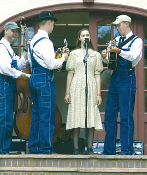 The Ackermans, a  family bluegrass group (from left, dad
Randy and high schoolers Aaron, Rebekah and Jeremy) play on the stage at the back of the Orchard House. 
Westside Pioneer photo