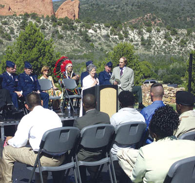 Speaking for Garden of the Gods Foundation founder Lyda
Hill (who could not be present), Bonnie Frum, director of
operations for the Garden of the Gods Visitor & Nature
Center, congratulates the new citizens at the immigration
ceremonies. To her left stands Congressman Joel Hefley.
Westside Pioneer photo