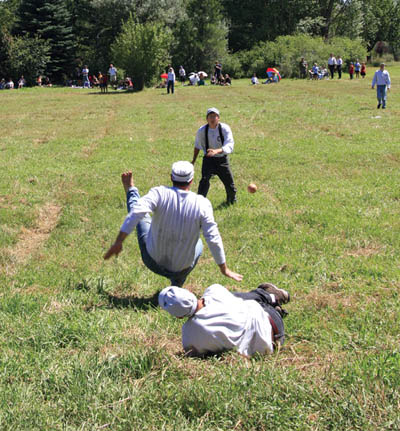 During the vintage baseball game at Rock Ledge Ranch on Labor Day, a Denver All-Star blooper falls safe in right field 
despite the valiant efforts of three Cloud Buster players (from top to bottom, Andrew Sledge Fisk, J.J. Professor Stevens and Bret Tracker Tennis).
Westside Pioneer photo