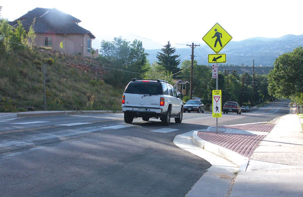 A car crests the Uintah hill at the recently built crosswalk/ bumpout near the Katharine Lee Bates Apartments. A proposed 
Uintah project would create �sharrow� lanes in which bicylists could use part of the traffic lane each way.
Westside Pioneer photo