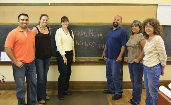 Terra Nova Engineering owner Luanne Rubey (third from
left) and several of her staff make use of an old chalkboard
in one of the classrooms converted to office space at the
former Midland School. Others in the photo are (from left) Mike Cartmell, Vanessa Bean, Quentin Armijo, Laura Espinoza and Mary Manren.
Westside Pioneer photo