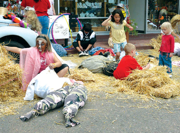Kids use plenty of straw for the Old Town Plaza merchants� scarecrow-making contest Saturday, Sept. 27. 
Westside Pioneer photo