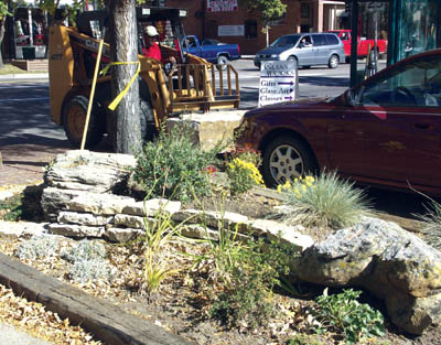 Mike Lucas uses a small loader Oct. 18 to place a rock along
the Colorado Avenue sidewalk near 25th Street as part of
the beautification effort by Old Town Plaza and the Old 
Colorado City Security & Maintenance District. The 
plantings in the foreground replaced a plaza parking space. 
Lucas and his father, John, make up Lucas Landscaping, 
the project contractor.
Westside Pioneer photo