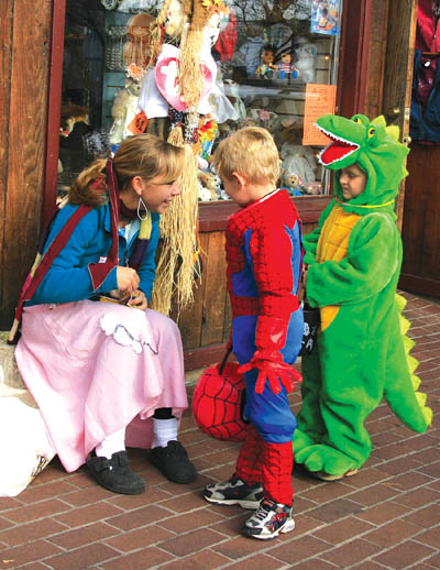 Liz Martin of Coronado High School chats with trick-or-treaters before giving them candy in the 2500 block of West Colorado Avenue during the annual 
Safe Treats in Old Colorado City Oct. 31.
Westside Pioneer photo