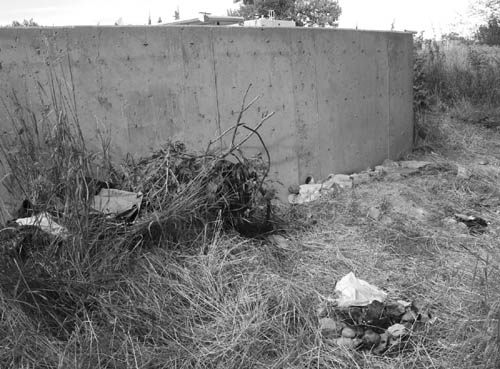At a camp where one homeless person shot another in the
summer of 2007 next to Fountain Creek behind the
Westside�s Sonic restaurant, some typical camp  debris can be seen � an empty liquor bottle, campfire ring, trash and discarded clothes.
Westside Pioneer file photo