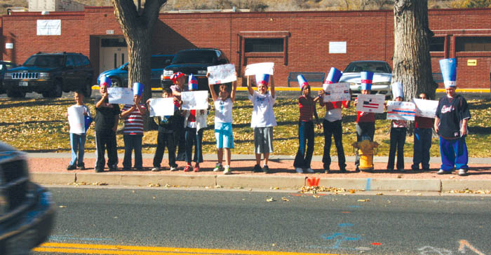 With Bristol Elementary a polling place Nov. 4, students
from Jackie Thompson�s fifth-grade class stand in front of
their school along Walnut Street, reminding a passing motorist to vote. Inside, students held a mock presidential election.
Westside Pioneer photo