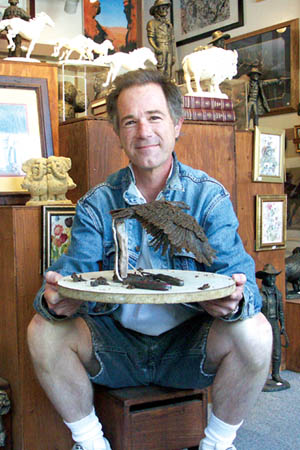 In this photo from September 2004, Rick Lewis posed in his
Old Colorado City gallery with the eagle he was working on at the time.
Westside Pioneer file photo
