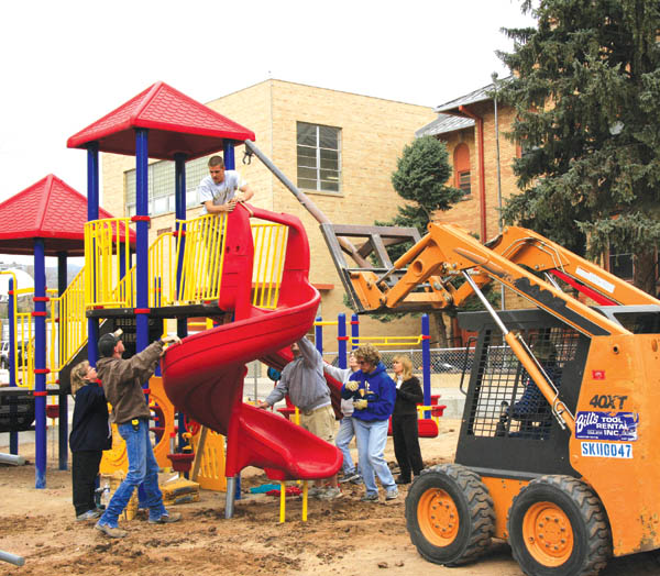 On Nov. 12, a loader lifts another playground unit into
place as the project nears completion. With pea gravel still
to be laid, the Whittier students will get to start using the equipment next week, according to Berg.
Westside Pioneer photo