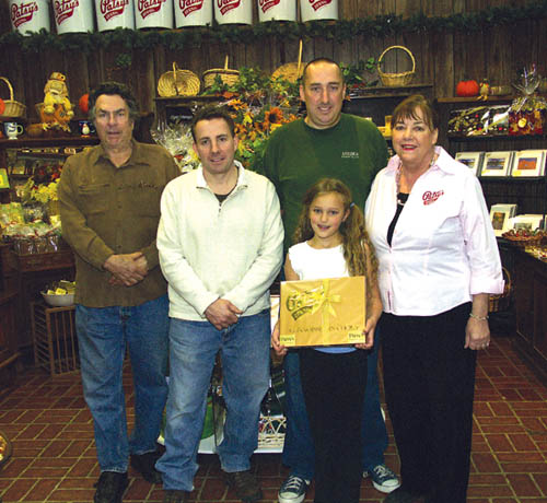 Three Niswonger generations are shown inside the Patsy’s Candies retail store. From left are Wes, his sons Mike and 
Si, Si’s daughter Georgia and Wes’ wife Annette.
Westside Pioneer photo