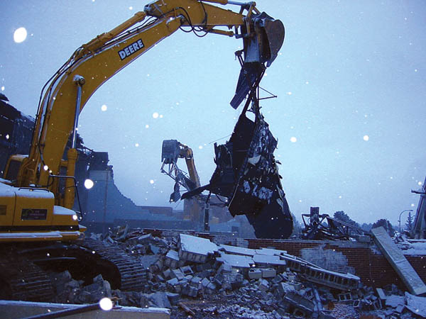 Backhoes from project contractor Gerald H. Phipps
Construction chew up debris from the old Coronado High
School auditorium amid swirling snowflakes in the late afternoon Dec. 8. 
Courtesy of Ryan McAllister