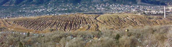 The rills on the hill (as seen looking south from Promontory 
Point Park) represent years of uncontrolled run-off from the
old Golden Cycle gold-milling property. The old mills 
smokestack is at the far right. The drainage problem was 
inherited by Gold Hill Mesa Township LLC, the current 
property owners who are planning the Gold Hill Mesa 
residential/commercial development. The LLCs engineers 
are planning a type of terracing in place of the rills to help in
slowing stormwater flow and preventing any contaminants 
from reaching Fountain Creek. The LLC has also submitted
 a grading plan for the upper part of the property, which, if 
approved, would allow leveling to start in January in the 
Phase 1 area of the project. Click to see story and project 
concept plan.
Westside Pioneer photo