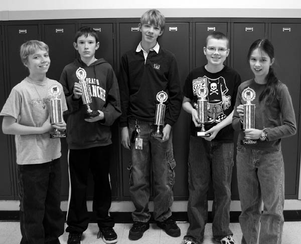 The individual champions on West Middle School�s math team hold up five of the six first-place team trophies that
the school garnered in the competition against six District 11 schools Dec. 8. They are (from left)  Ian Carroll, James
Disney, Jacob Carson, David Lang and Moriah Yeh. In all, West won five individual and six team firsts out of 18
possible at the event. The West team had 27 members in all. 
Westside Pioneer photo