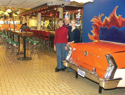 The family leadership of the new Ritas Fajitas restaurant
consists of (from left) wife and husband Janice Blackwood
and Rip Blackwood and their daughter, Susie Kepler. They
are standing by the back end of a 1956 Buick that is being
retrofitted as a salsa bar. The liquor bar and the main dining
area can be seen behind them.
Westside Pioneer photo