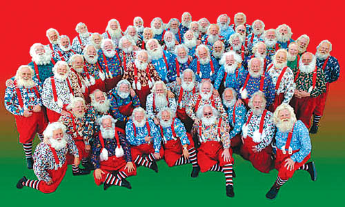 Multiple Santas with Naturally Santa Inc. pose for a photo
recently. In addition to requiring real beards, the Westside-
based agency gets away from the traditional coat and
gloves. The idea is to present Santa more informally, as he
might look in his workshop, according to operations
manager Santa Joe Monaco. This also makes it easier to get
down on the floor, if need be, to better relate to children, 
he noted.
Courtesy of Naturally Santa Inc.